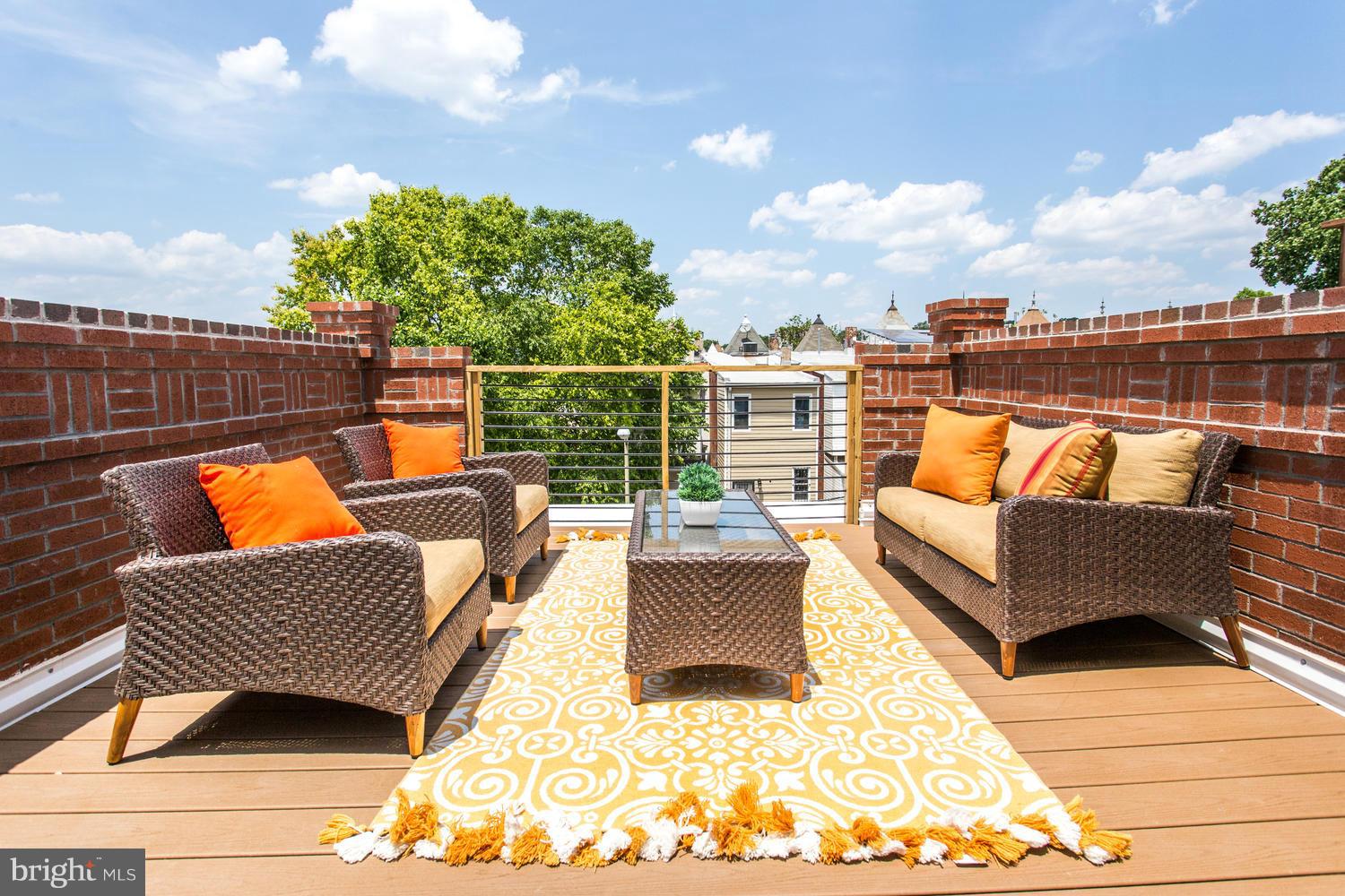 59 Randolph Place Northwest, Unit PH Washington, DC 20001 - Photo 24 of 27 a view of a roof deck with couches and potted plants