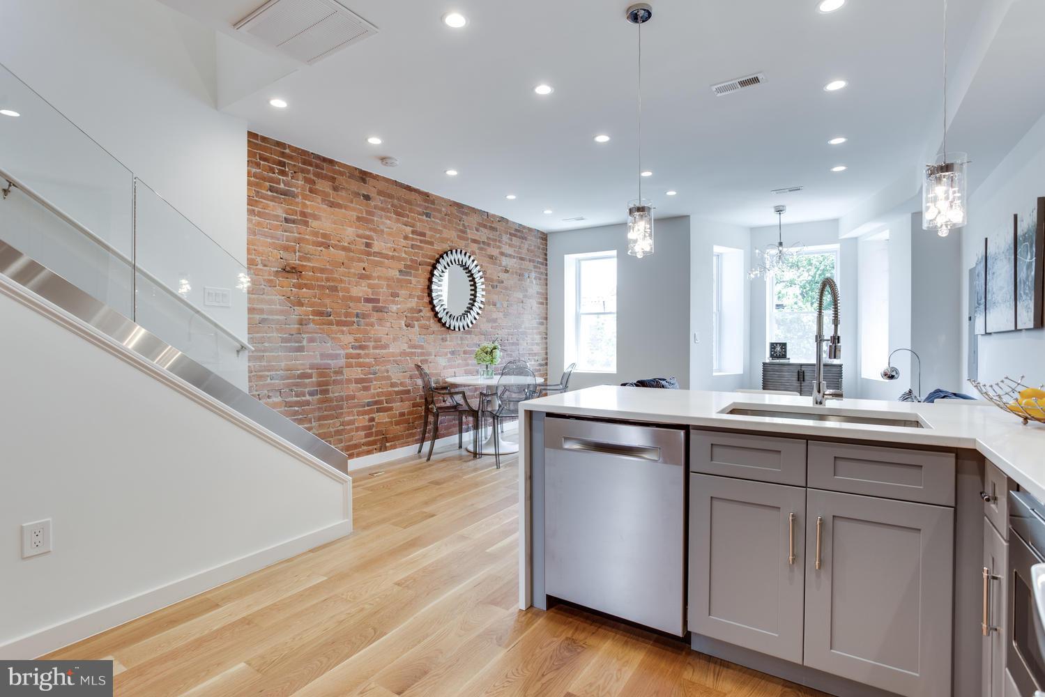 59 Randolph Place Northwest, Unit PH Washington, DC 20001 - Photo 6 of 27 a kitchen with a sink cabinets and wooden floor