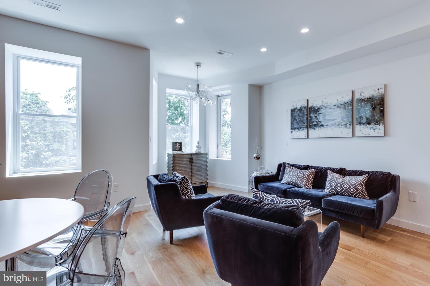59 Randolph Place Northwest, Unit PH Washington, DC 20001 - Photo 7 of 27 a living room with furniture and a large window