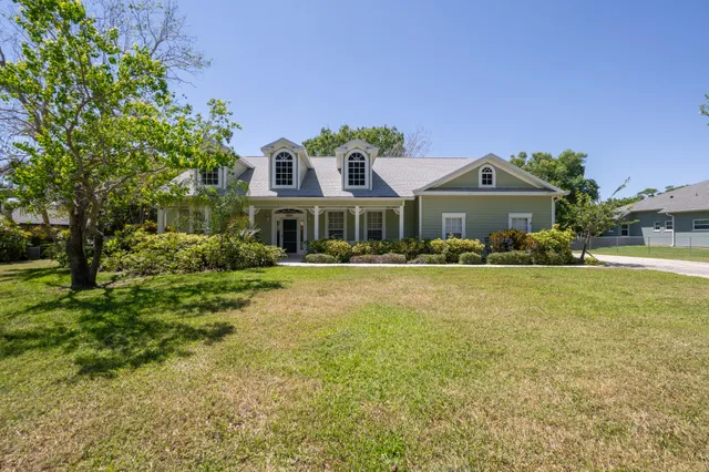 a front view of a house with a yard table and chairs