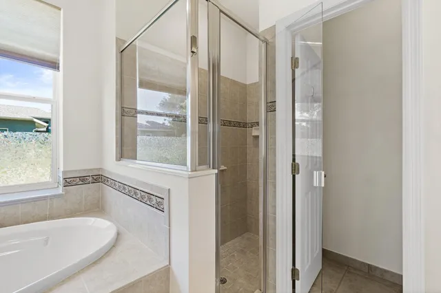a white bath tub sitting next to a window