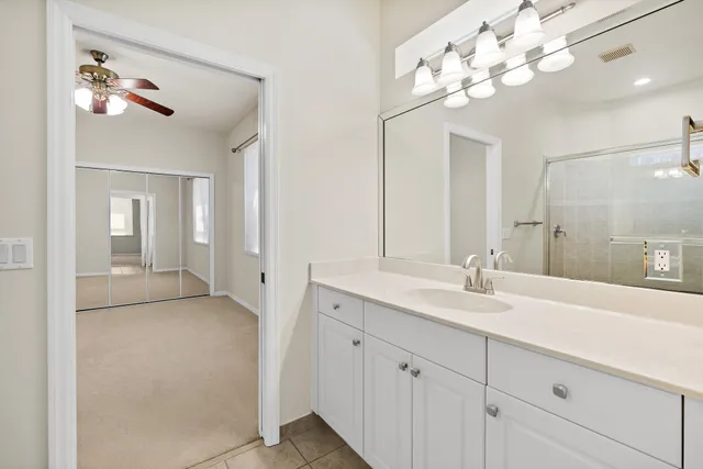 a bathroom with a shower a toilet and a window