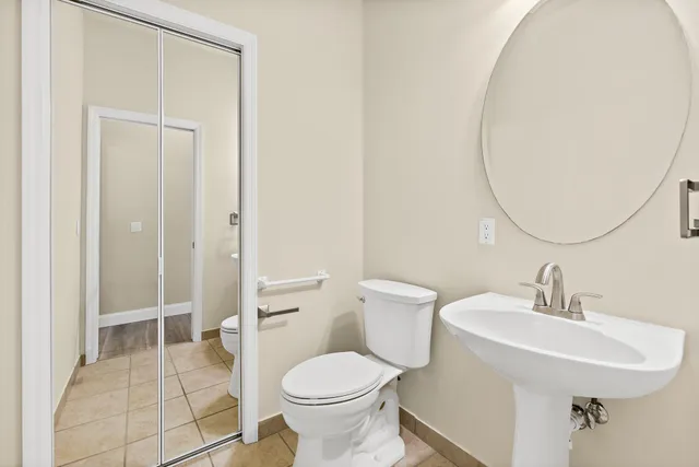 a view of house with a big yard and potted plants