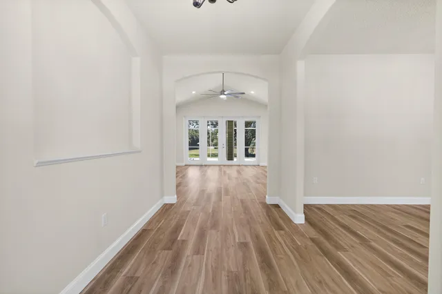 a view of a room with wooden floor and windows