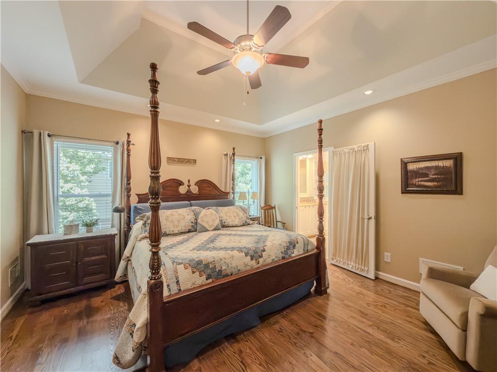 4284 Cedar Bluff Way Southwest Lilburn, GA 30047 - Photo 11 of 62 a bedroom with a bed a couch and a ceiling fan