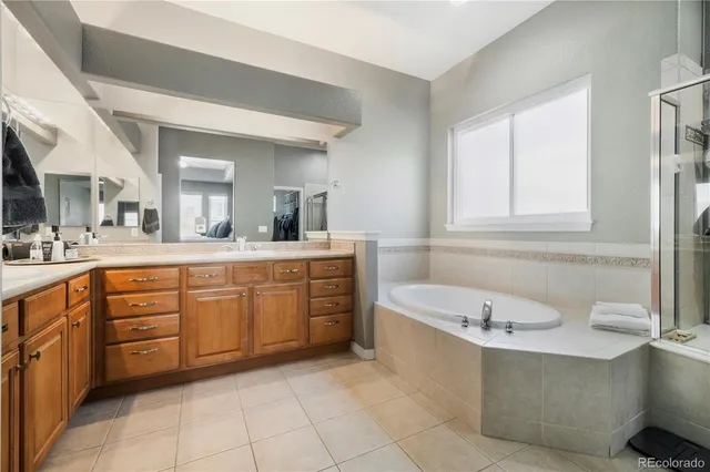 a bathroom with a granite countertop sink mirror and bathtub
