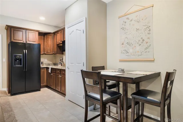 a kitchen with stainless steel appliances kitchen island granite countertop a refrigerator and a stove top oven