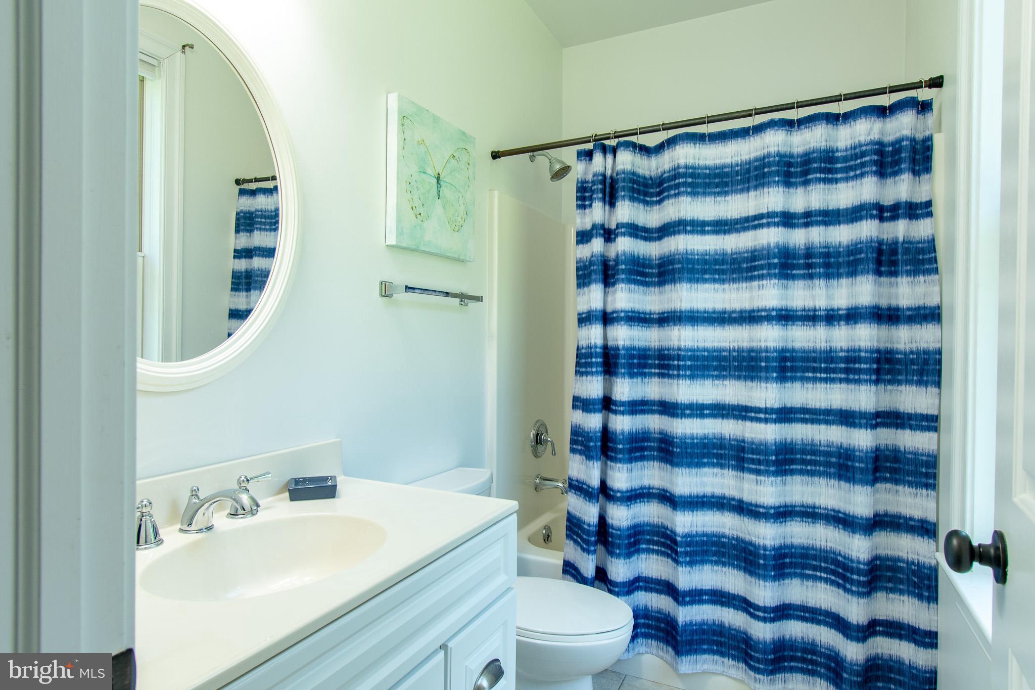 7841 Pea Neck Road St. Michaels, MD 21663 - Photo 28 of 41 a bathroom with a sink a toilet and shower