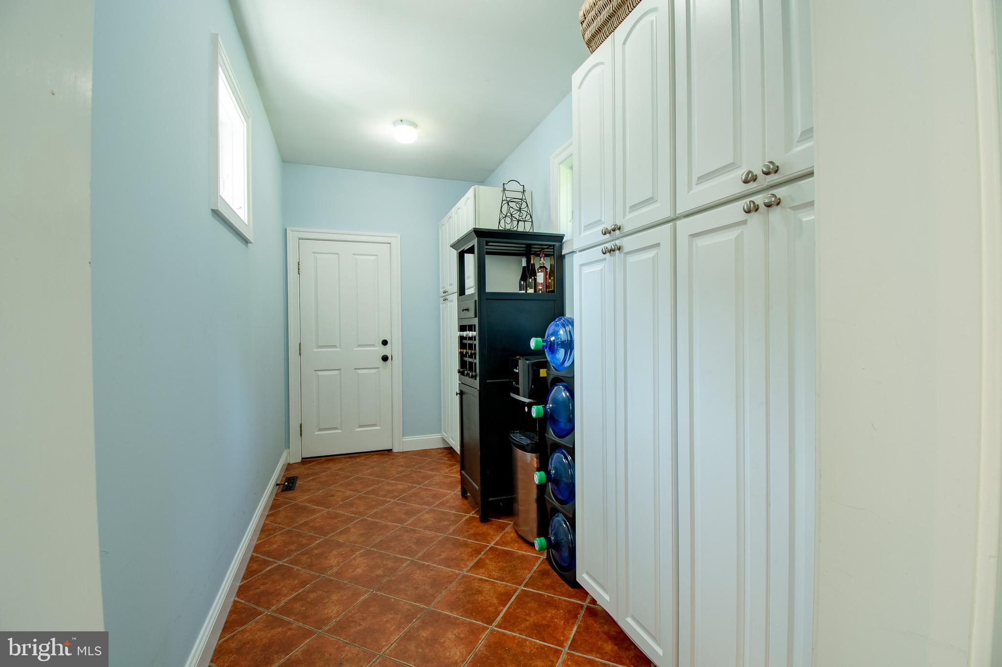 7841 Pea Neck Road St. Michaels, MD 21663 - Photo 30 of 41 a view of a hallway with wooden shelves