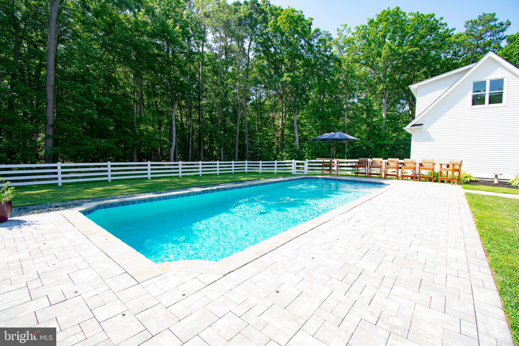 7841 Pea Neck Road St. Michaels, MD 21663 - Photo 40 of 41 a view of swimming pool with a backyard and trees