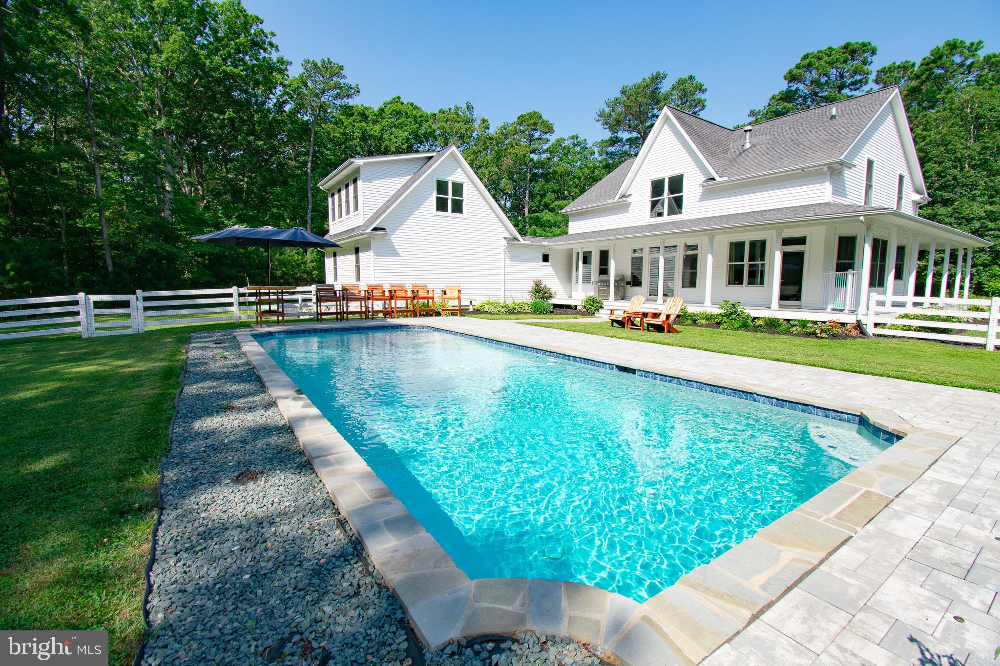 7841 Pea Neck Road St. Michaels, MD 21663 - Photo 41 of 41 a front view of house with swimming pool and green space