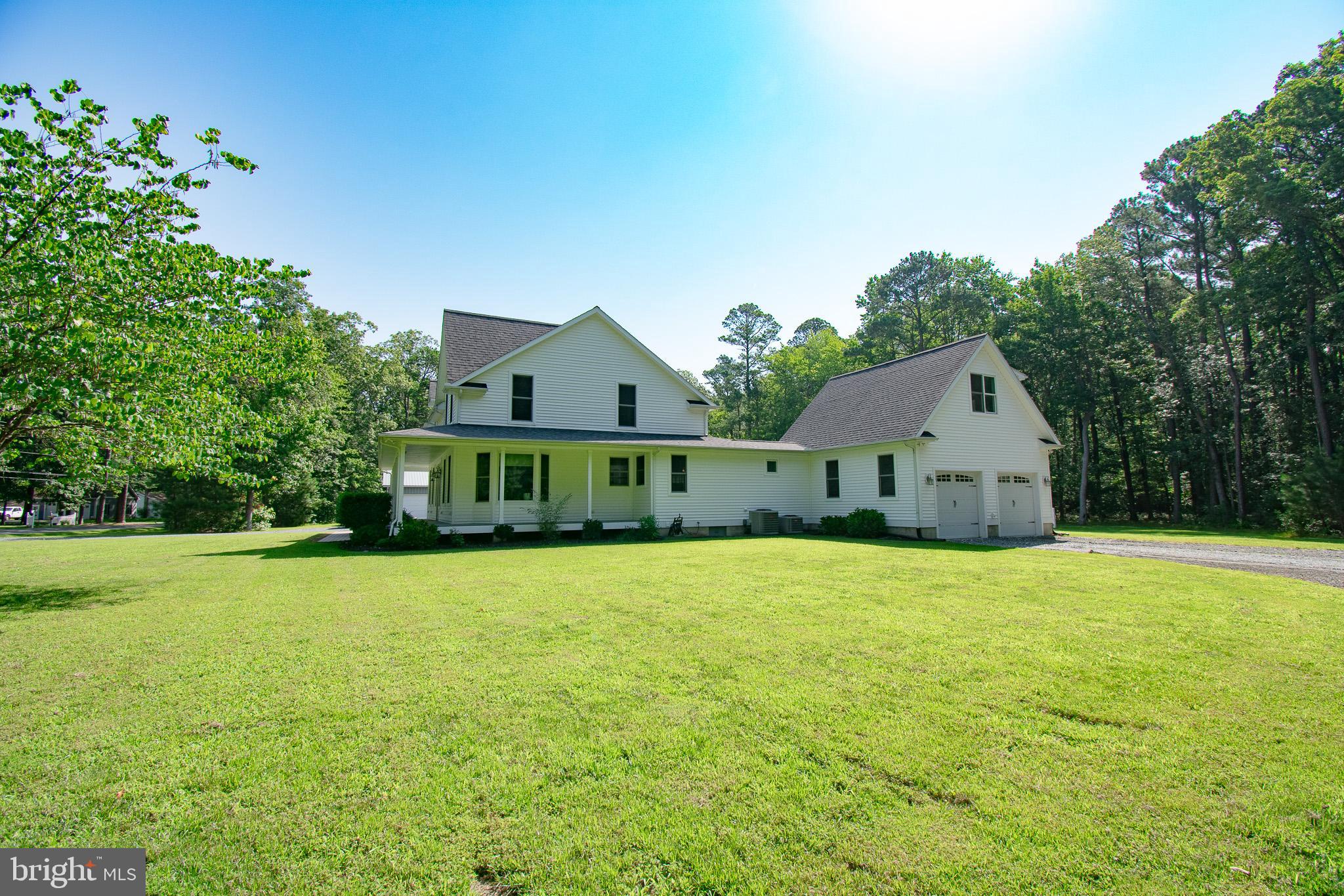 7841 Pea Neck Road St. Michaels, MD 21663 - Photo 6 of 41 a front view of a house with a garden