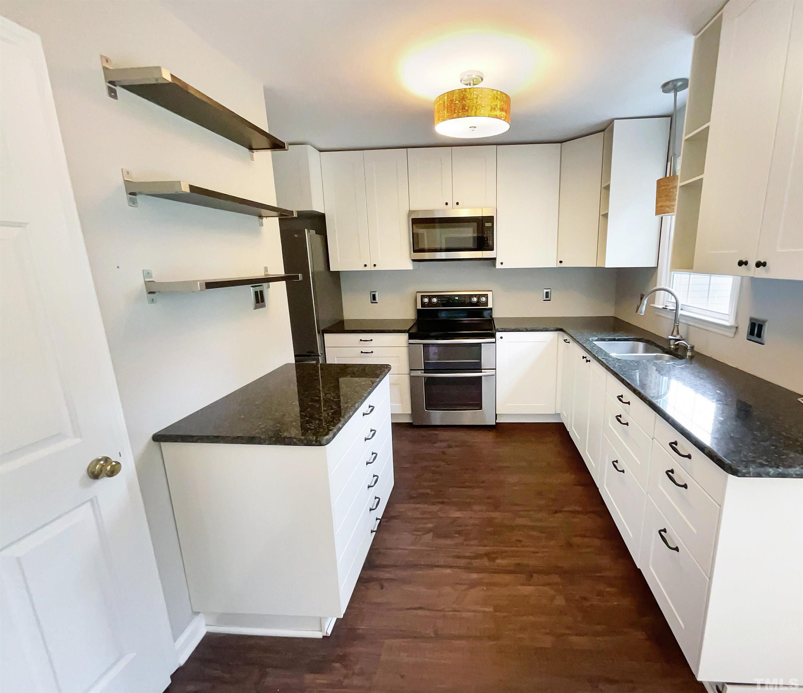 4521 Draper Road Raleigh, NC 27616 - Photo 4 of 17 a kitchen with granite countertop a sink stove and refrigerator