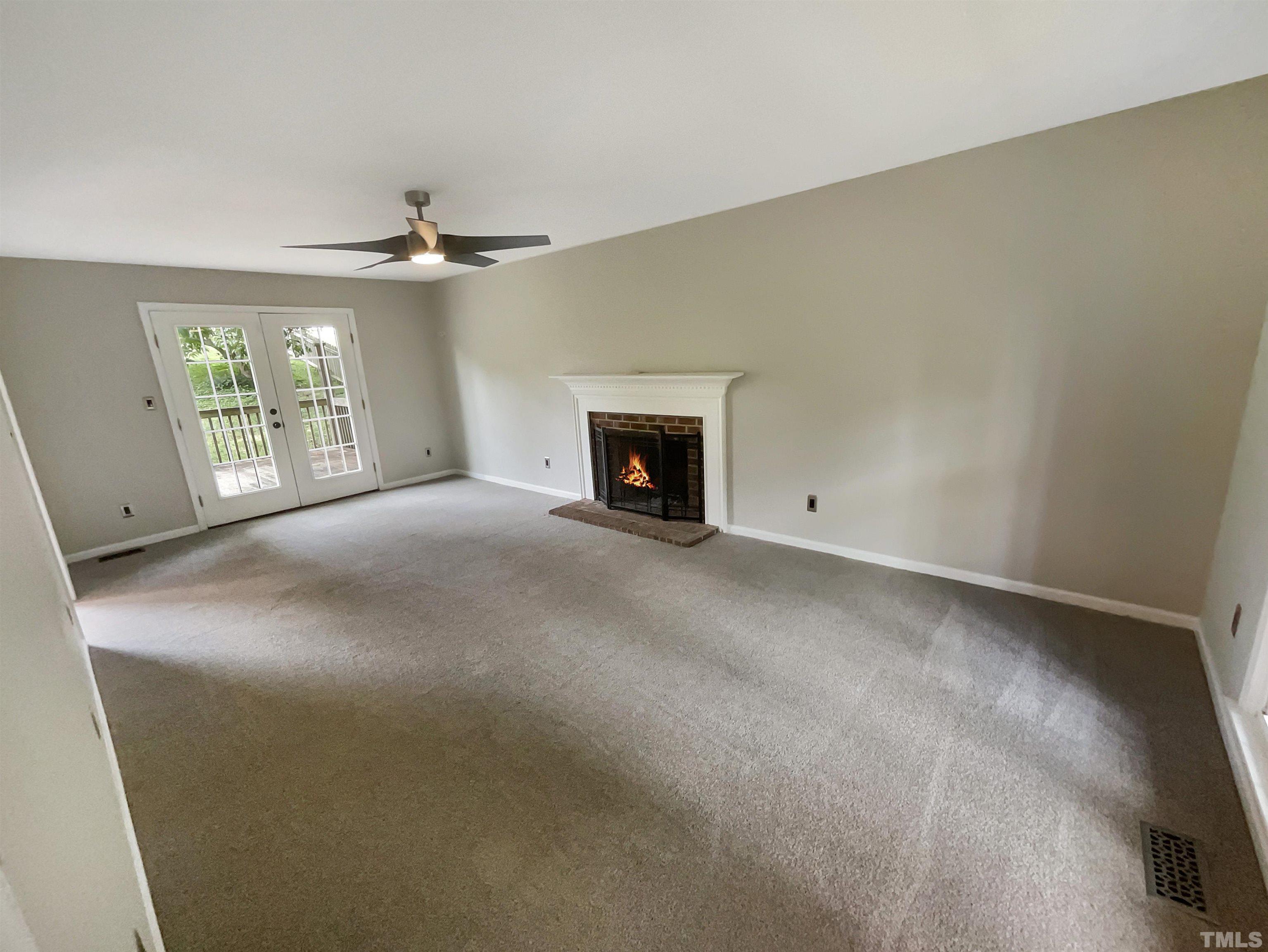 4521 Draper Road Raleigh, NC 27616 - Photo 8 of 17 an empty room with windows and fireplace