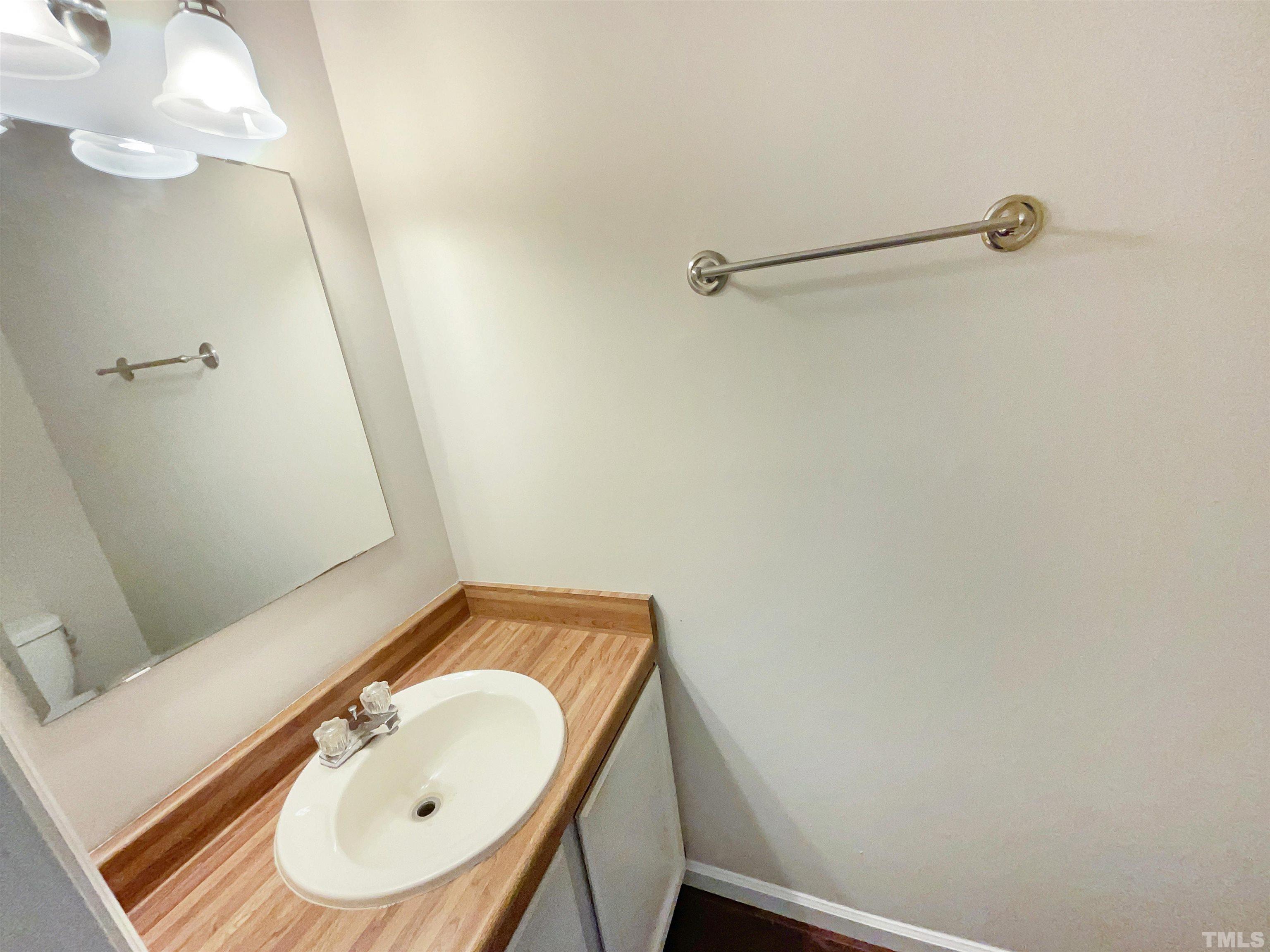 4521 Draper Road Raleigh, NC 27616 - Photo 10 of 17 a bathroom with a sink and a mirror
