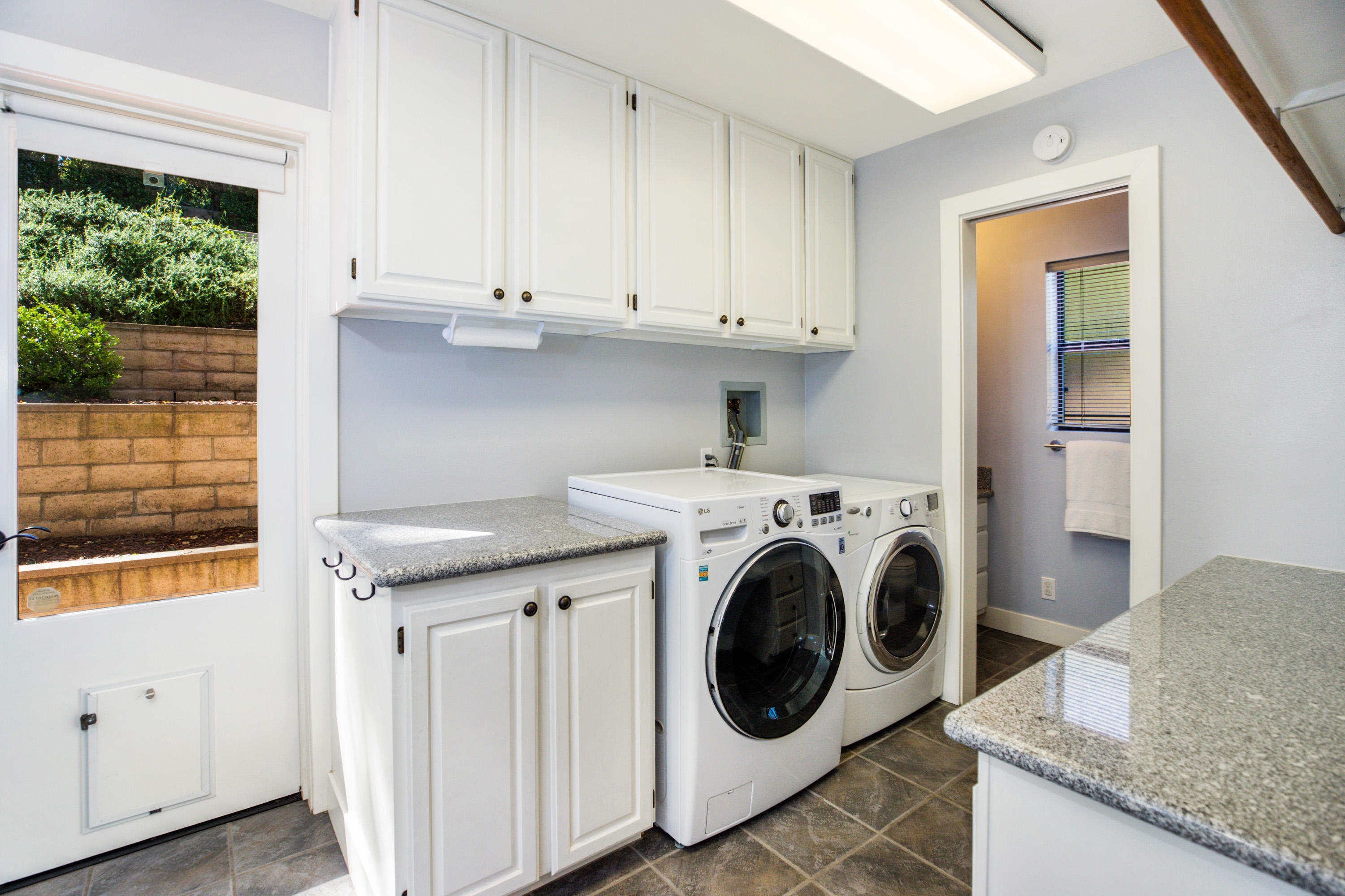 907 Fellowship Road Santa Barbara, CA 93109 - Photo 15 of 21 a utility room with granite countertop a sink a washer and dryer next to a window
