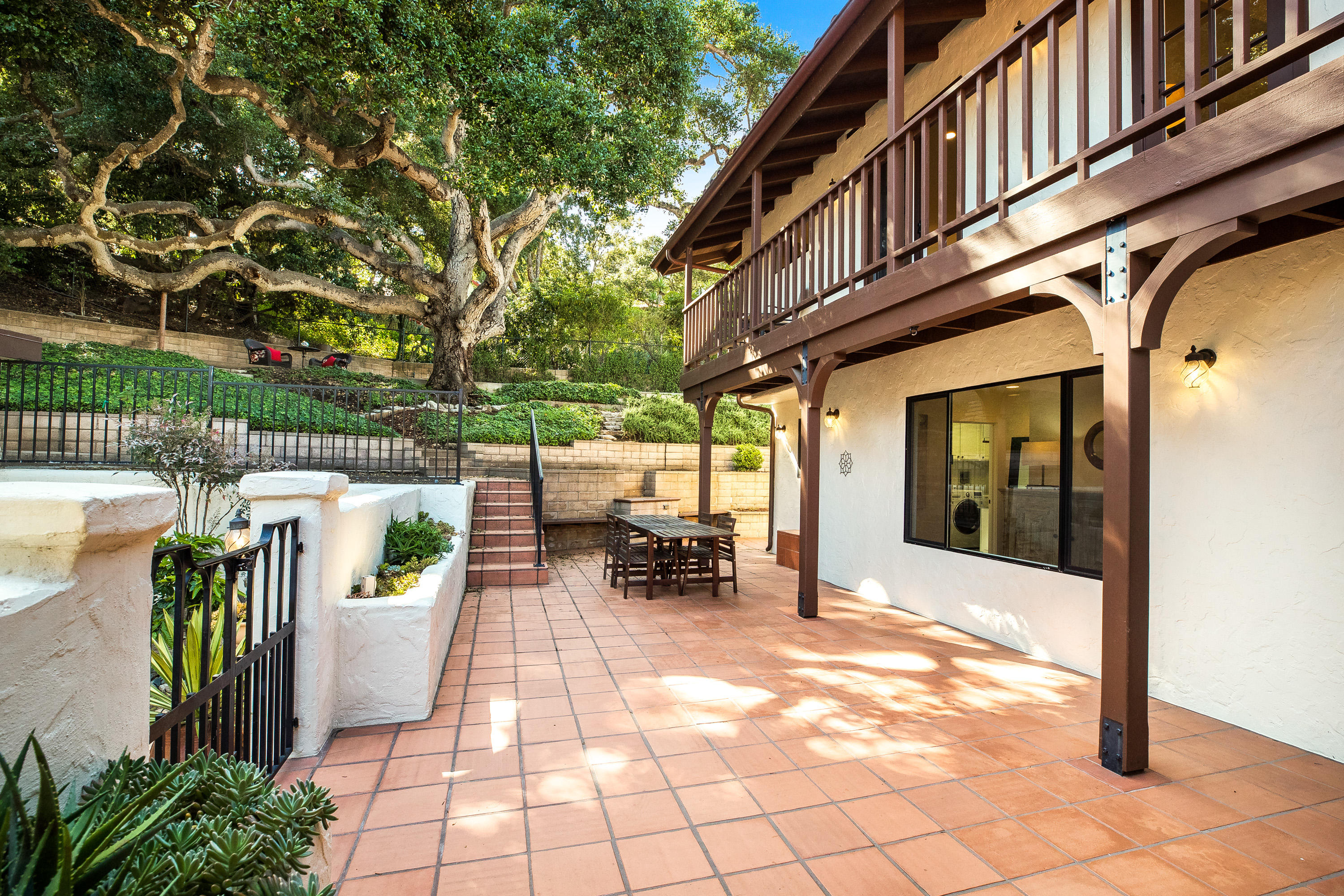 907 Fellowship Road Santa Barbara, CA 93109 - Photo 17 of 21 a view of a patio with table and chairs and potted plants