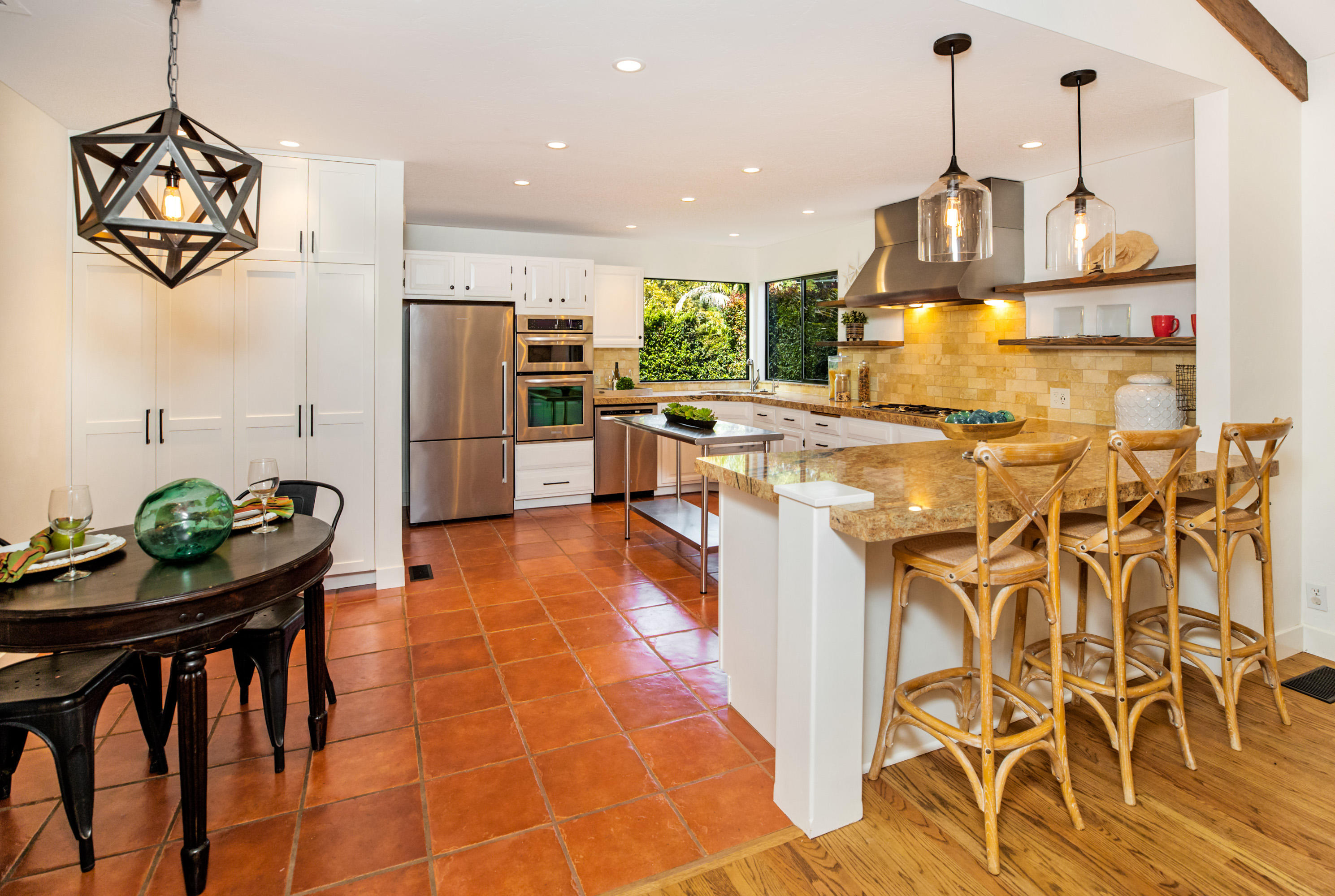 907 Fellowship Road Santa Barbara, CA 93109 - Photo 4 of 21 a kitchen with stainless steel appliances kitchen island granite countertop a table and chairs in it