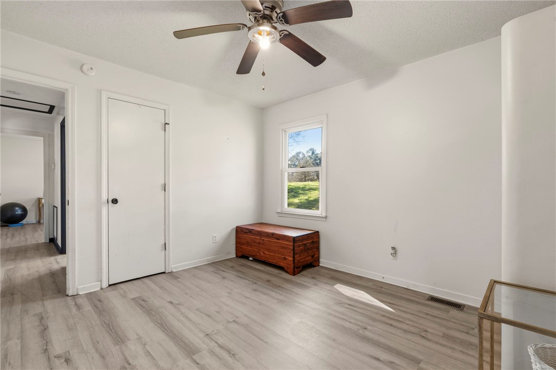 122 Latham Drive Anderson, SC 29621 - Photo 19 of 40 This bright room features a window overlooking lush greenery and sleek, modern flooring.