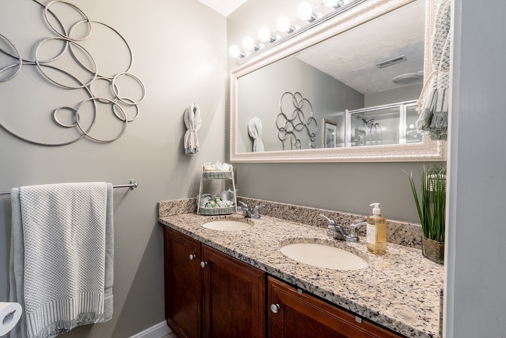 22 Duluth Street Worcester, MA 01604 - Photo 26 of 35 a bathroom with a granite countertop sink and a mirror