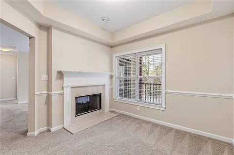 an empty room with furniture and a fireplace
