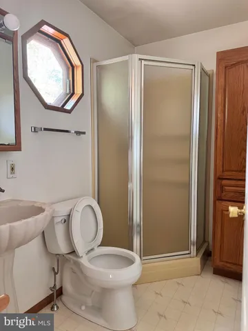 a bathroom with a toilet and a window