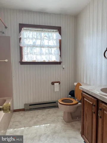 a bathroom with mirror and window