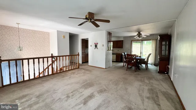 a view of a livingroom with furniture and a ceiling fan