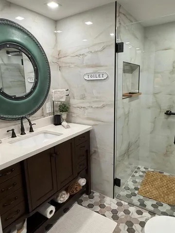 a kitchen with stainless steel appliances a refrigerator and microwave