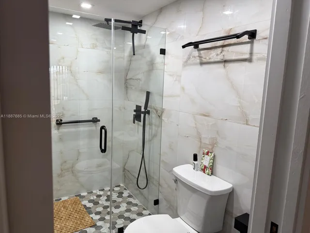 a picture of a wall with painting on the wall and a potted plant