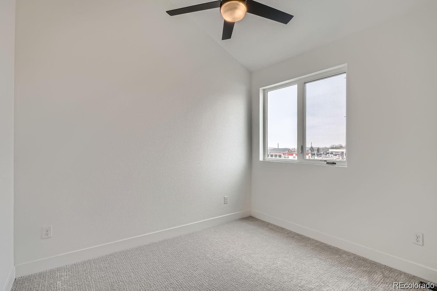 10187 West 38th Avenue Wheat Ridge, CO 80033 - Photo 16 of 50 an empty room with a window and a ceiling fan
