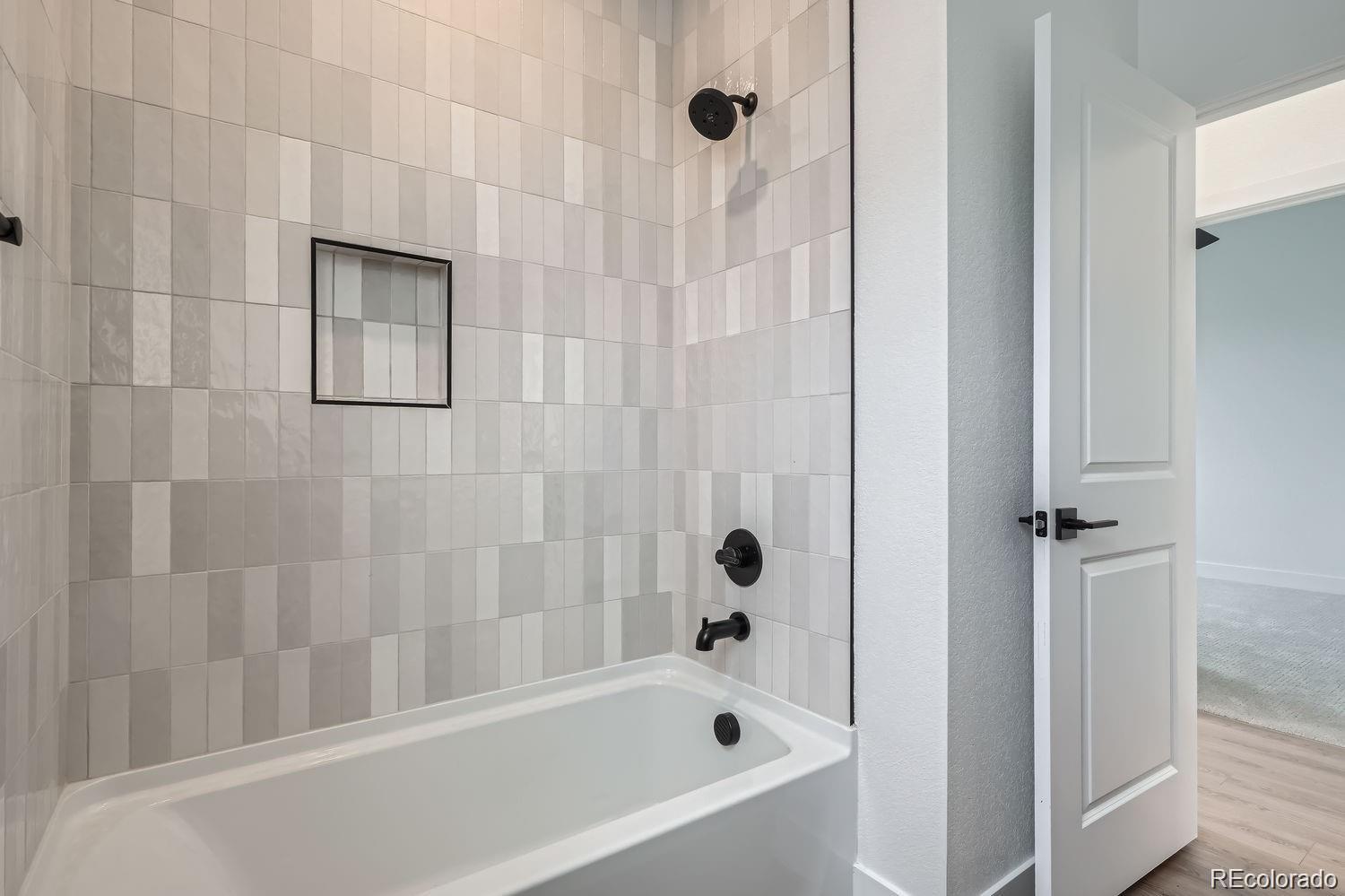 10187 West 38th Avenue Wheat Ridge, CO 80033 - Photo 18 of 50 a bathroom with a bathtub