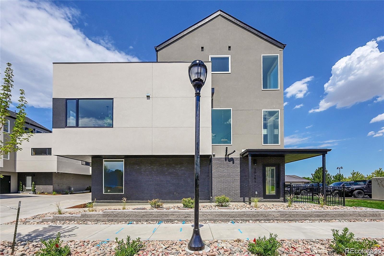 10187 West 38th Avenue Wheat Ridge, CO 80033 - Photo 2 of 50 a front view of a house with garage