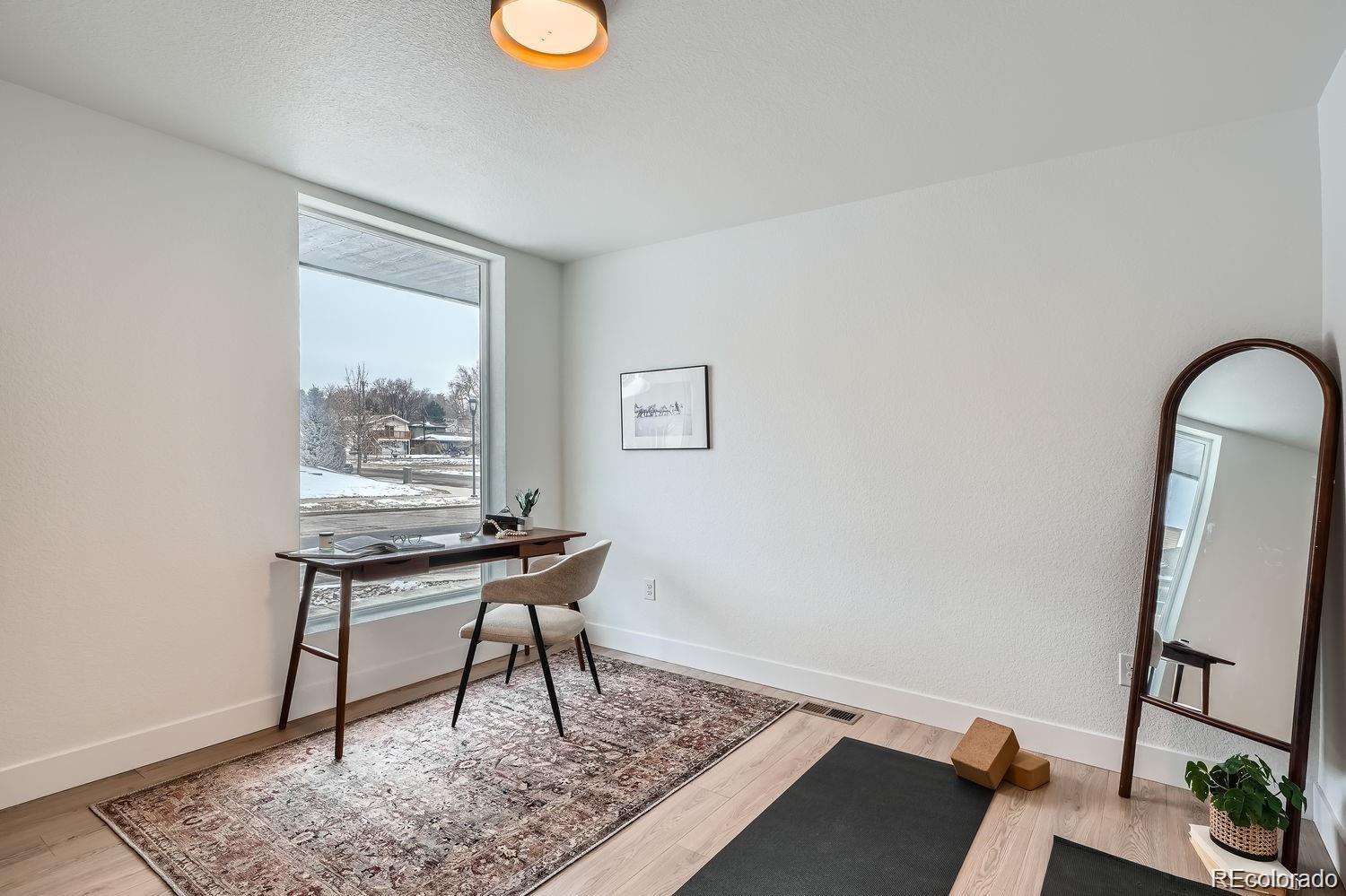 10187 West 38th Avenue Wheat Ridge, CO 80033 - Photo 4 of 50 a work room with furniture and a window
