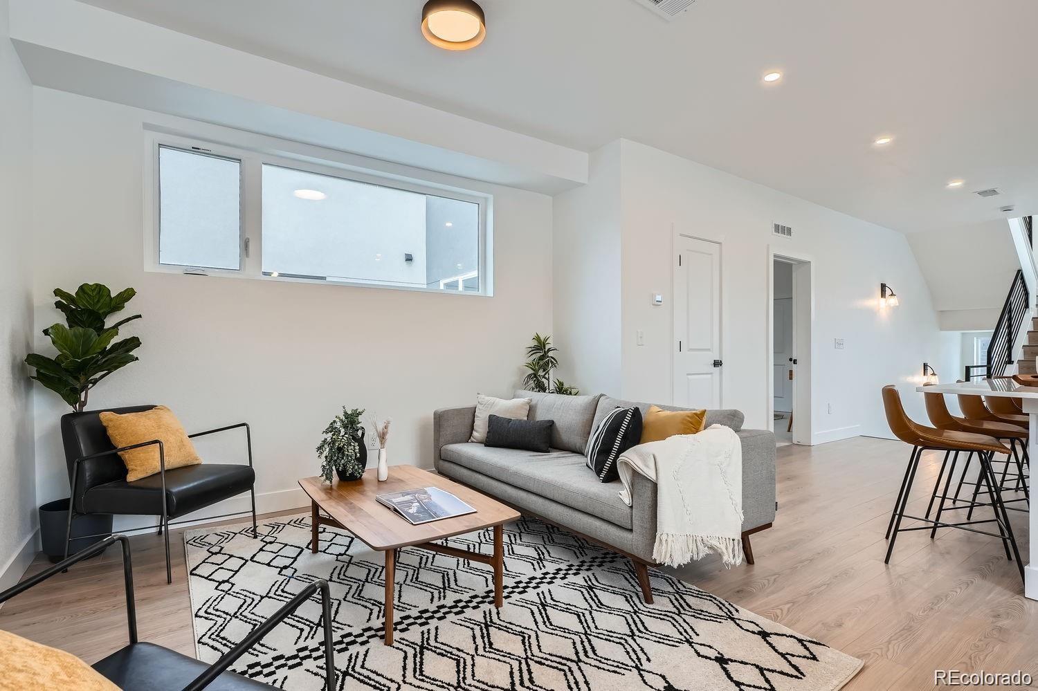 10187 West 38th Avenue Wheat Ridge, CO 80033 - Photo 10 of 50 a living room with furniture and wooden floor