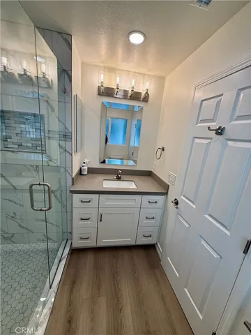 a bathroom with a double vanity sink toilet and shower
