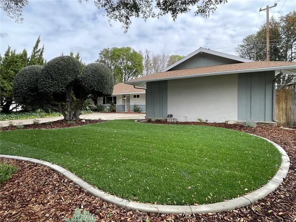 a view of a house with a yard porch and sitting area