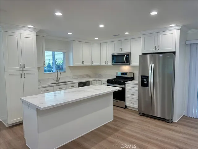 a kitchen with a refrigerator and a sink