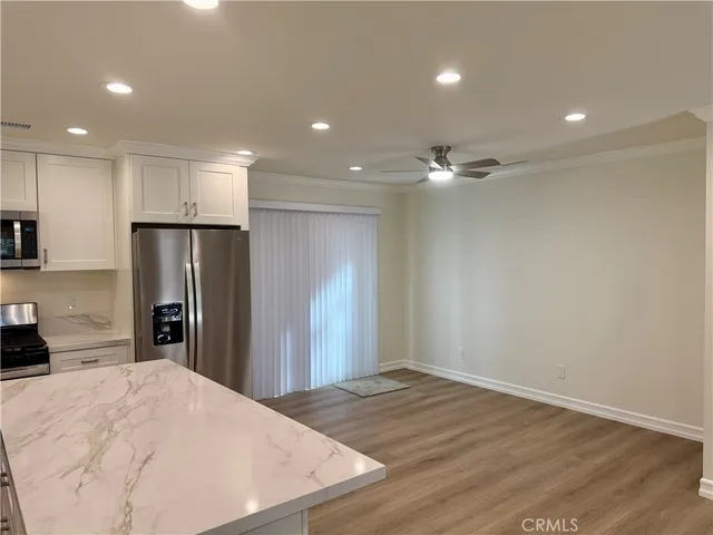 a view of a kitchen with a sink and refrigerator