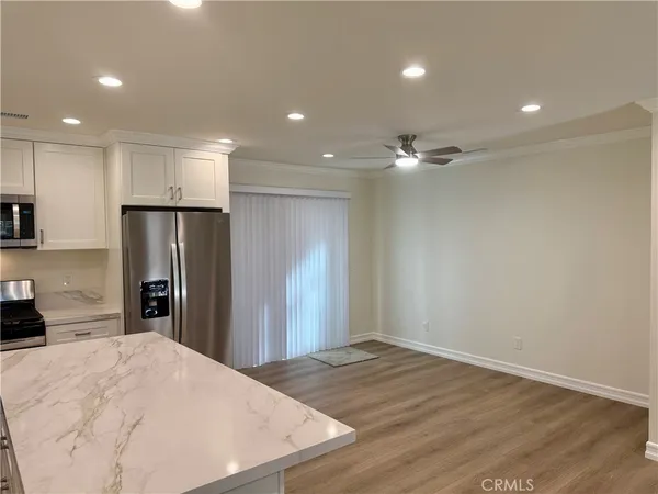 a view of a kitchen with a sink and refrigerator