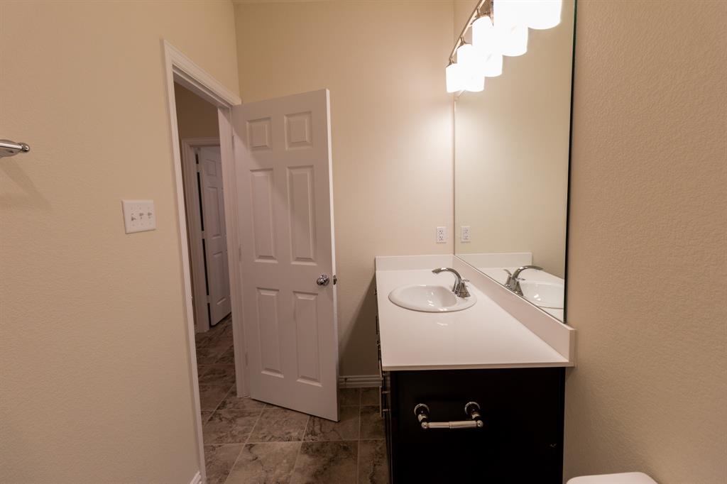 572 Ruthye Lane Pilot Point, TX 76258 - Photo 11 of 32 a bathroom with a sink and a mirror