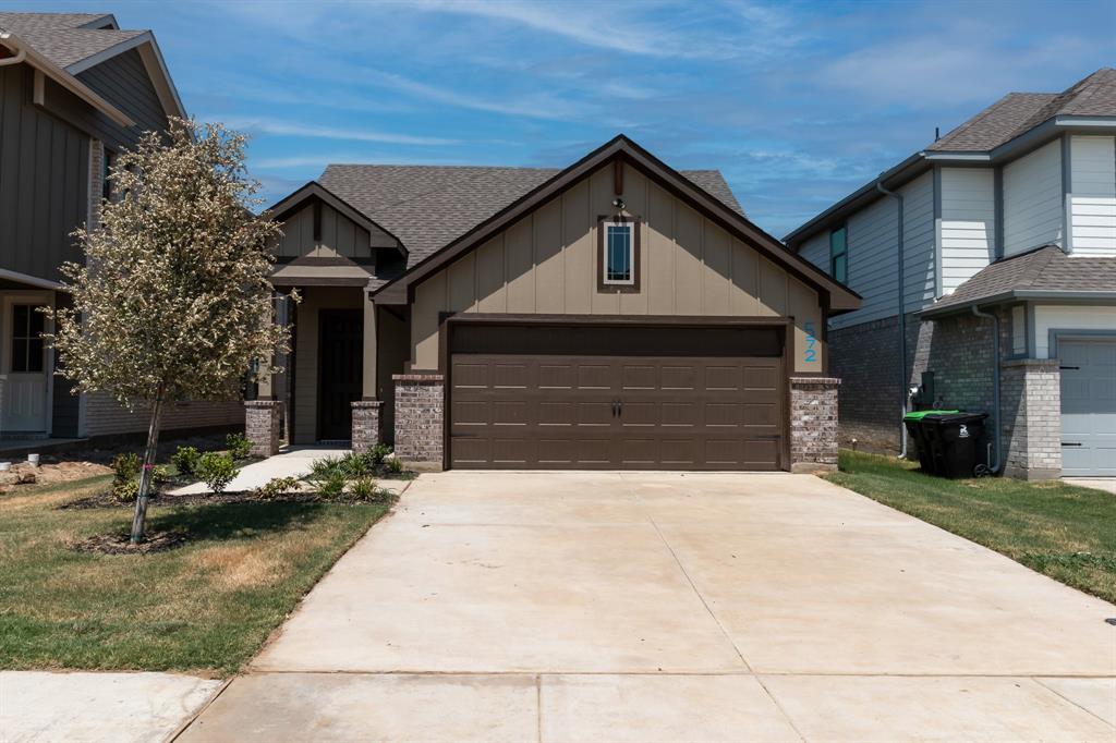 572 Ruthye Lane Pilot Point, TX 76258 - Photo 2 of 32 a front view of a house with a yard and garage