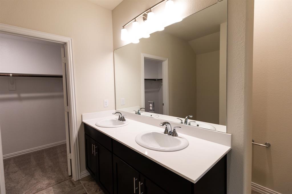572 Ruthye Lane Pilot Point, TX 76258 - Photo 23 of 32 a bathroom with a sink and a mirror
