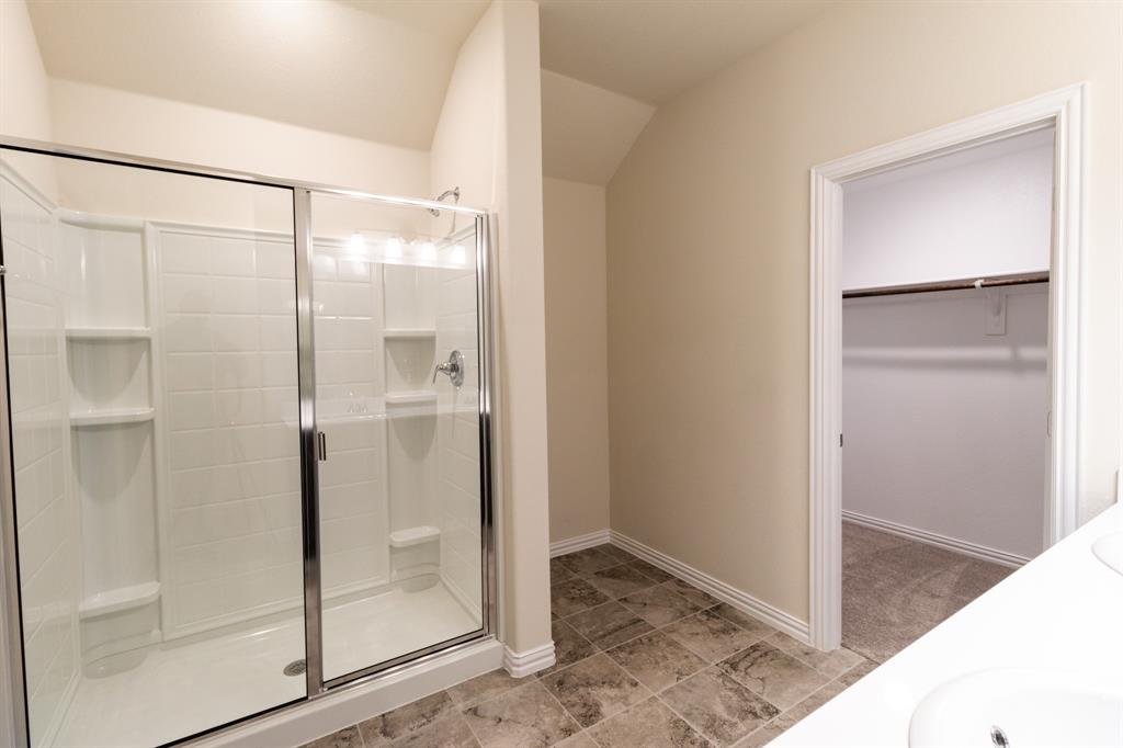 572 Ruthye Lane Pilot Point, TX 76258 - Photo 24 of 32 a bathroom with a glass shower door and a mirror