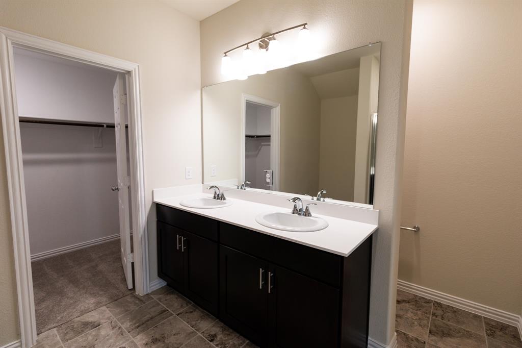 572 Ruthye Lane Pilot Point, TX 76258 - Photo 27 of 32 a bathroom with a double vanity sink and mirror
