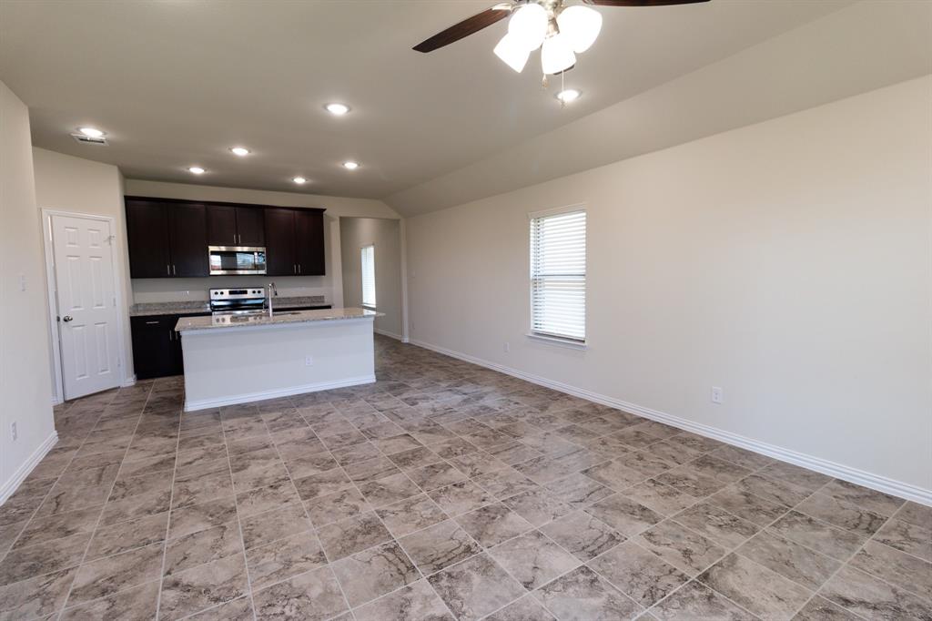 572 Ruthye Lane Pilot Point, TX 76258 - Photo 28 of 32 a view of kitchen with kitchen island stainless steel appliances a refrigerator sink and microwave