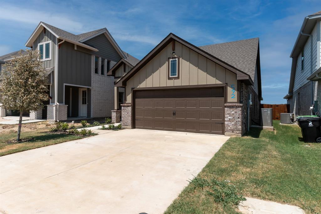 572 Ruthye Lane Pilot Point, TX 76258 - Photo 4 of 32 a front view of a house with a yard and garage