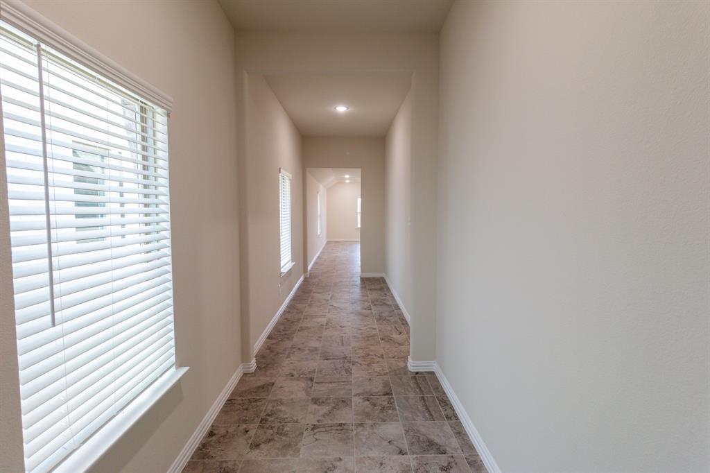 572 Ruthye Lane Pilot Point, TX 76258 - Photo 6 of 32 a view of a hallway with wooden floor and a large window