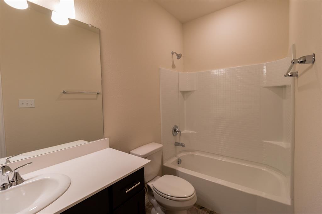 572 Ruthye Lane Pilot Point, TX 76258 - Photo 10 of 32 a bathroom with a sink a toilet and shower