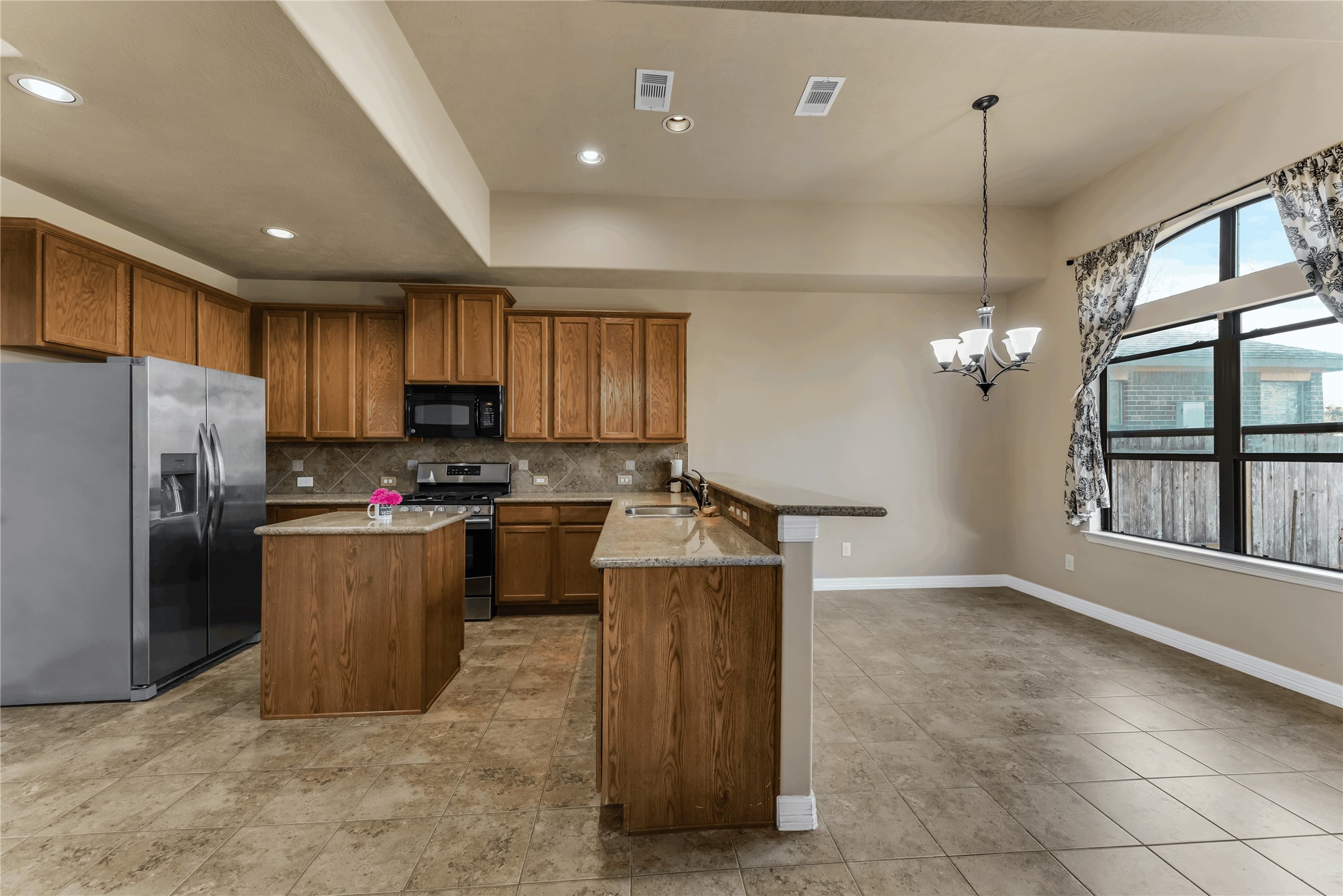 723 Audra Lane Spring, TX 77386 - Photo 12 of 35 a kitchen with refrigerator and cabinets